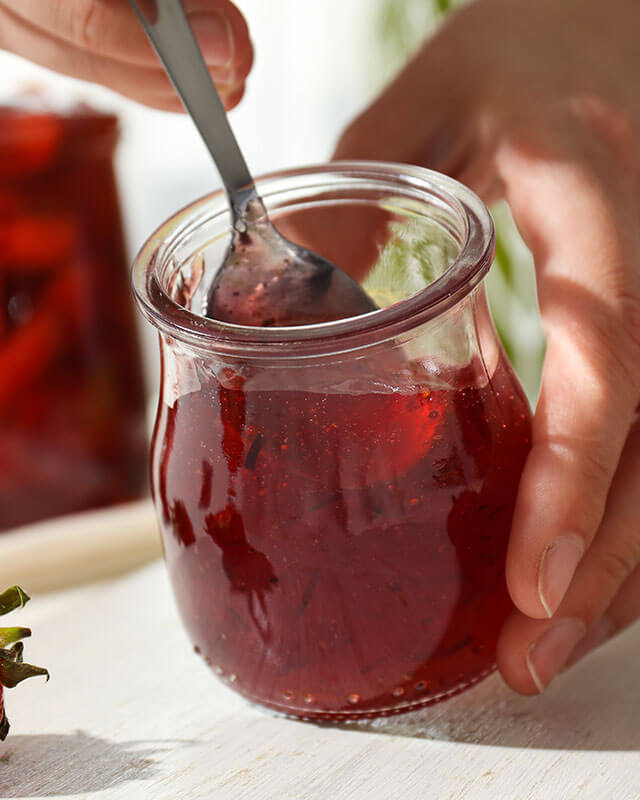 Sauces in jar being scooped with a spoon