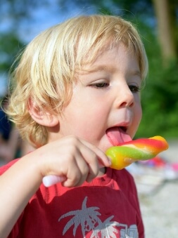 Kid eating a frozen lollipop