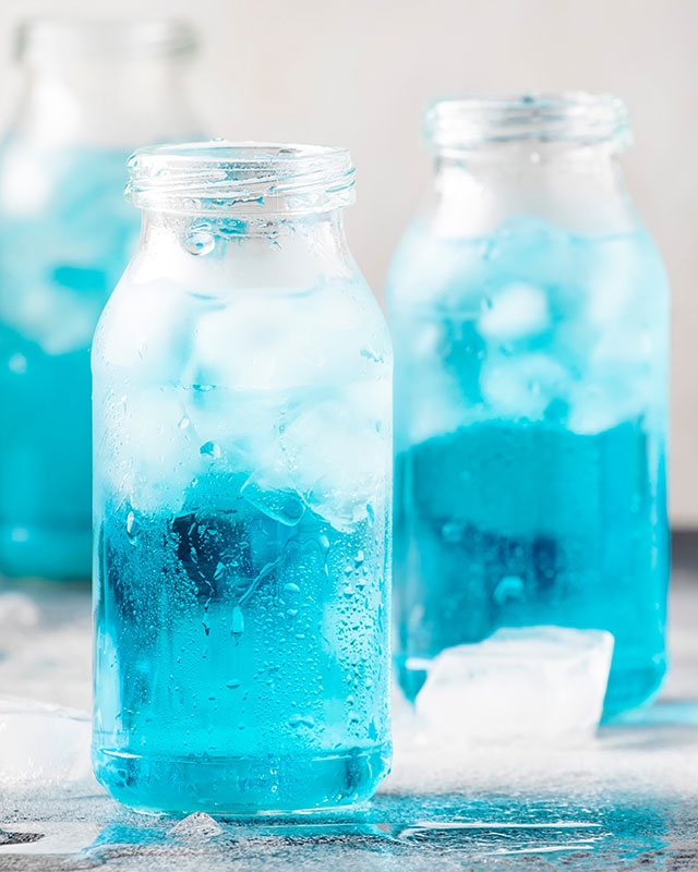 3 jars with blue beverage in ice