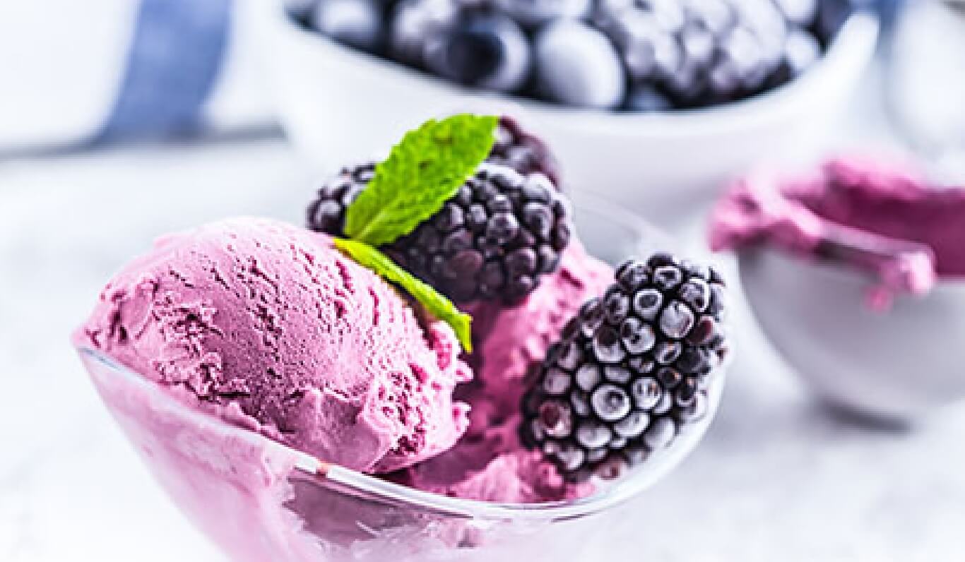 Raspberry ice cream in glass bowl